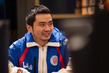 Xiao8 smiling while his team prepares to compete at TI12.