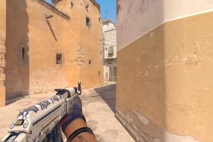 A player with an AK in their left hand on Dust 2 in CS2.
