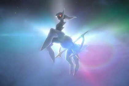 Arceus against a glowing rainbow background.