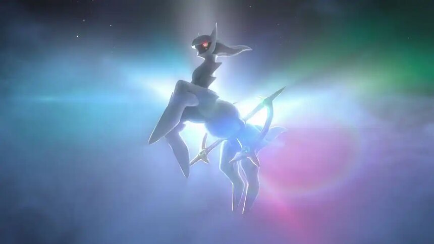 Arceus against a glowing rainbow background.